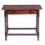 A 17TH CENTURY OAK SIDE TABLE with overhanging plank top above a single frieze drawer; standing on