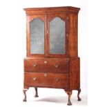 A QUEEN ANNE BURR ELM MIRRORED CABINET ON CHEST with moulded short grain cornice above a pair of