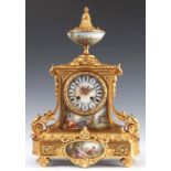 A LATE 19TH CENTURY FRENCH ORMOLU AND PORCELAIN PANELLED MANTEL CLOCK the case with urn finial above