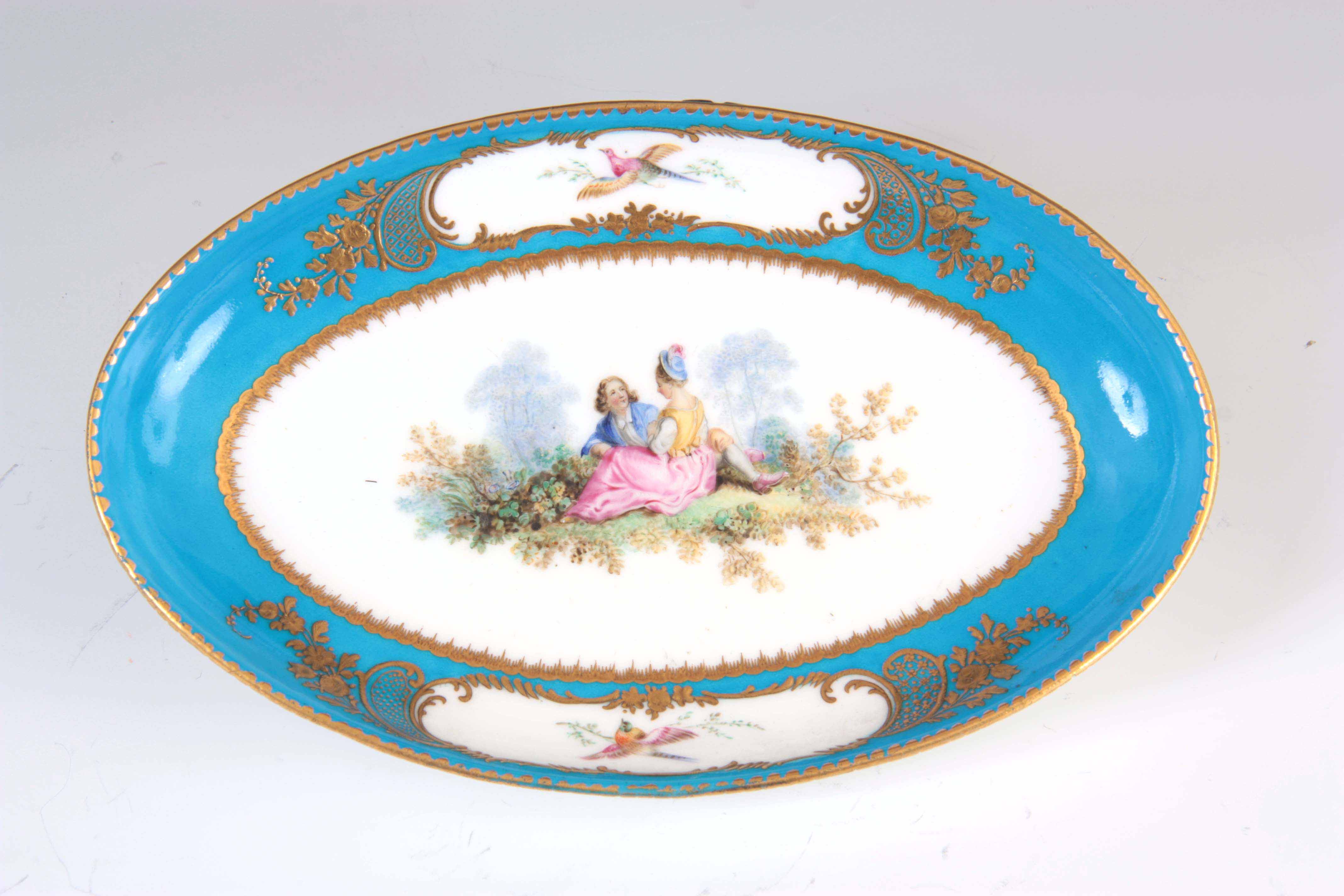 A FINE 18TH CENTURY SEVRES PORCELAIN SHALLOW OVAL DISH on a gilded celestial blue ground decorated