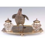 A LATE 19TH CENTURY NICKEL INKSTAND MOUNTED WITH A COLD PAINTED BRONZE PARTRIDGE having two tapering