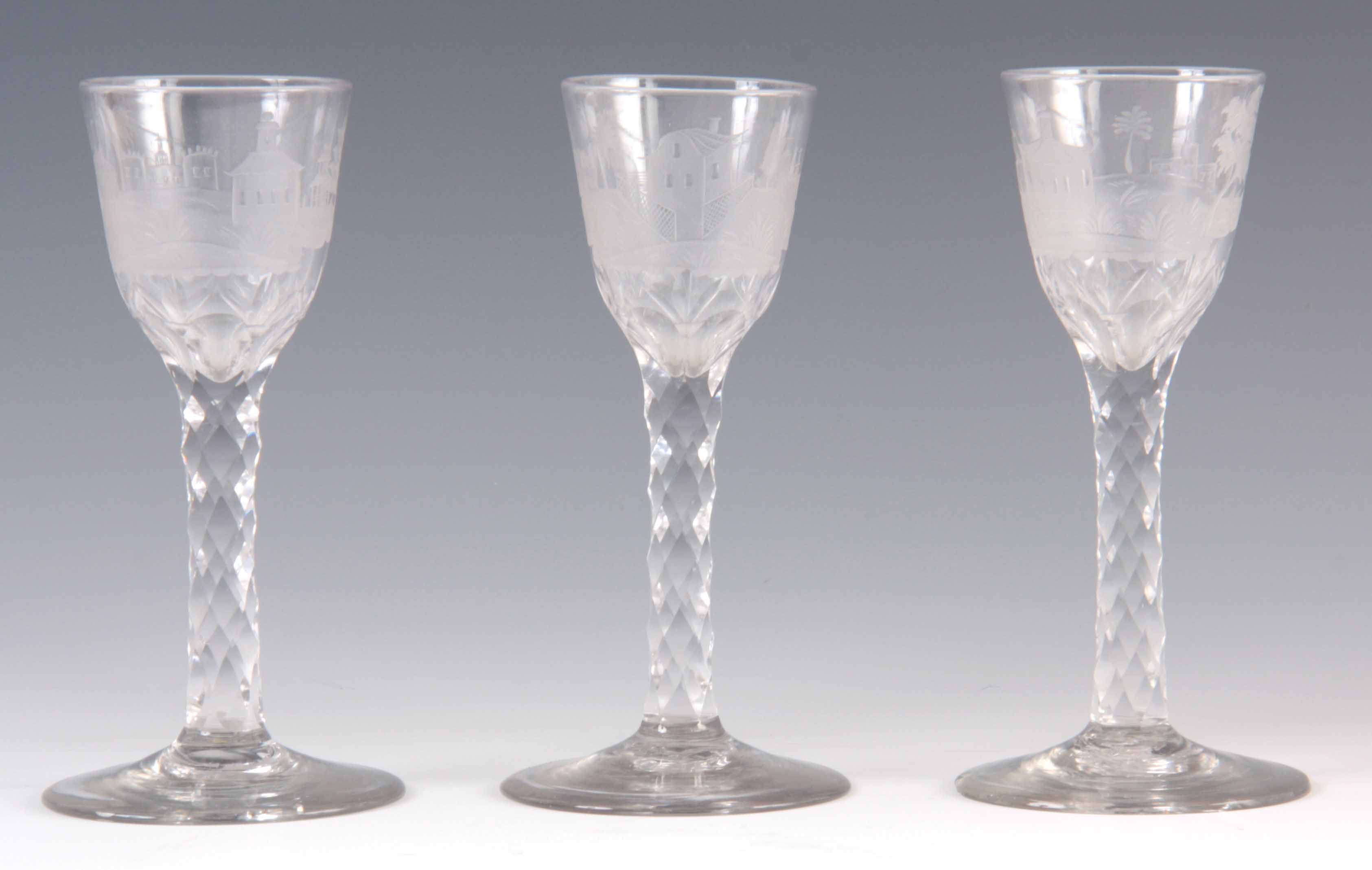 A SET OF THREE GEORGIAN ENGLISH WINE GLASSES with unusual etched scenes depicting Chinese pagodas in