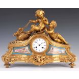 A LATE 19TH CENTURY FRENCH ORMOLU AND PORCELAIN PANELLED FIGURAL MANTEL CLOCK surmounted by a