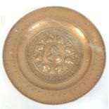 A LARGE EARLY 18TH CENTURY BRASS ALMS DISH having embossed Latin moto surrounding central figure