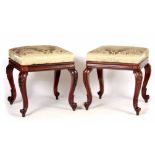 A PAIR OF LATE REGENCY ROSEWOOD STOOLS with upholstered cushion tops; standing on carved cabriole