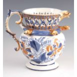 A RARE 19TH CENTURY DOUBLE ACTION SERPENT HEAD PUZZLE JUG, with reticulated rim, blue and white with