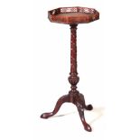 A LATE GEORGIAN MAHOGANY CARVED WINE TABLE with a figured octagonal shaped top with pierced gallery;