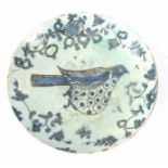 18TH/19TH CENTURY PERSIAN DISH decorated in blue and white with a plump bird and foliage 5cm high