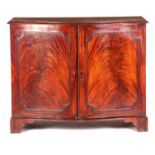 A GEORGE III FLAMED MAHOGANY SERPENTINE FRONTED COMMODE having moulded edge top above a pair of