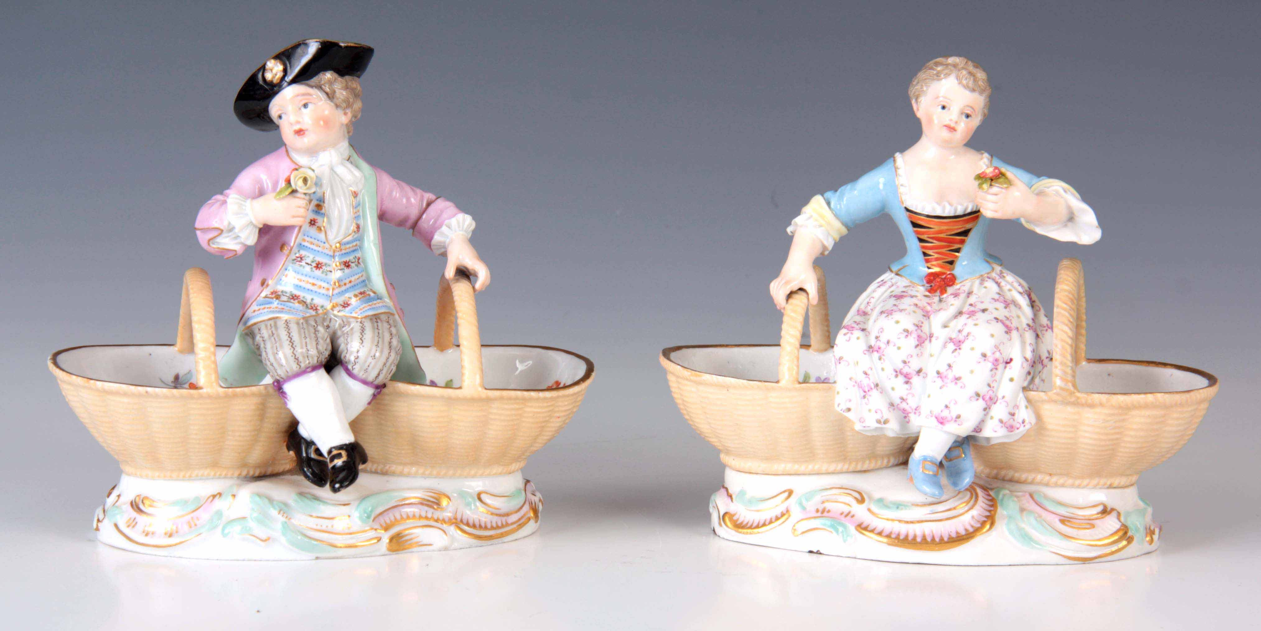 A PAIR OF 19TH CENTURY MEISSEN PORCELAIN TABLE SALTS depicting a young boy and girl sat between
