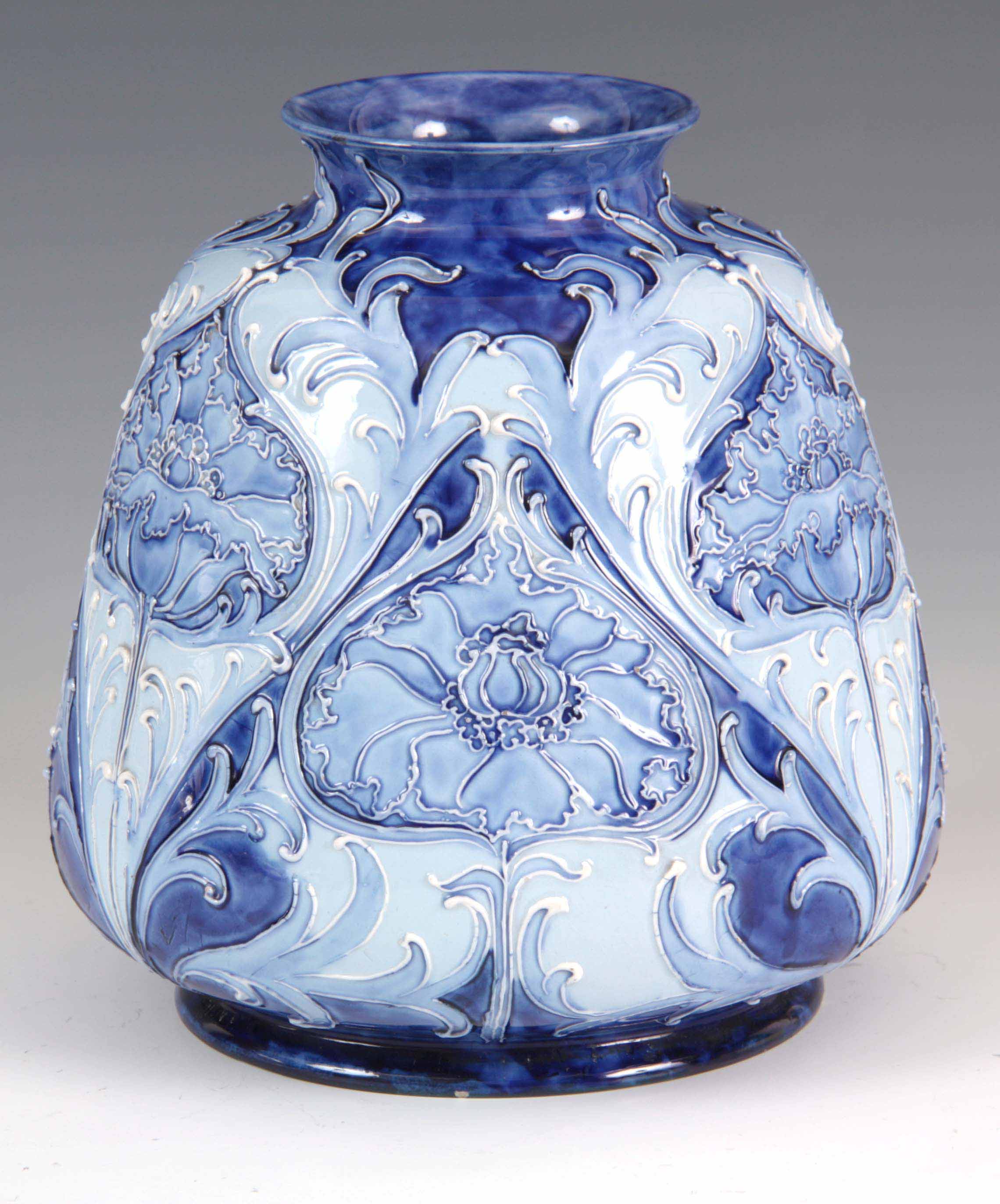 A FLORIAN WARE MOORCROFT VASE with stylised piped floral decoration with a printed label for '