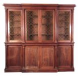 AN EARLY 19TH CENTURY MAHOGANY BREAKFRONT BOOKCASE IN THE MANOR OF GILLOWS having moulded cornice