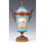 A 19TH CENTURY SEVRES ORMOLU MOUNTED PORCELAIN VASE AND COVER with mask head side handles and