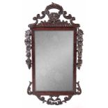 A 19TH CENTURY CARVED MAHOGANY ROCOCO STYLE HANGING MIRROR with flowerhead and leaf carved