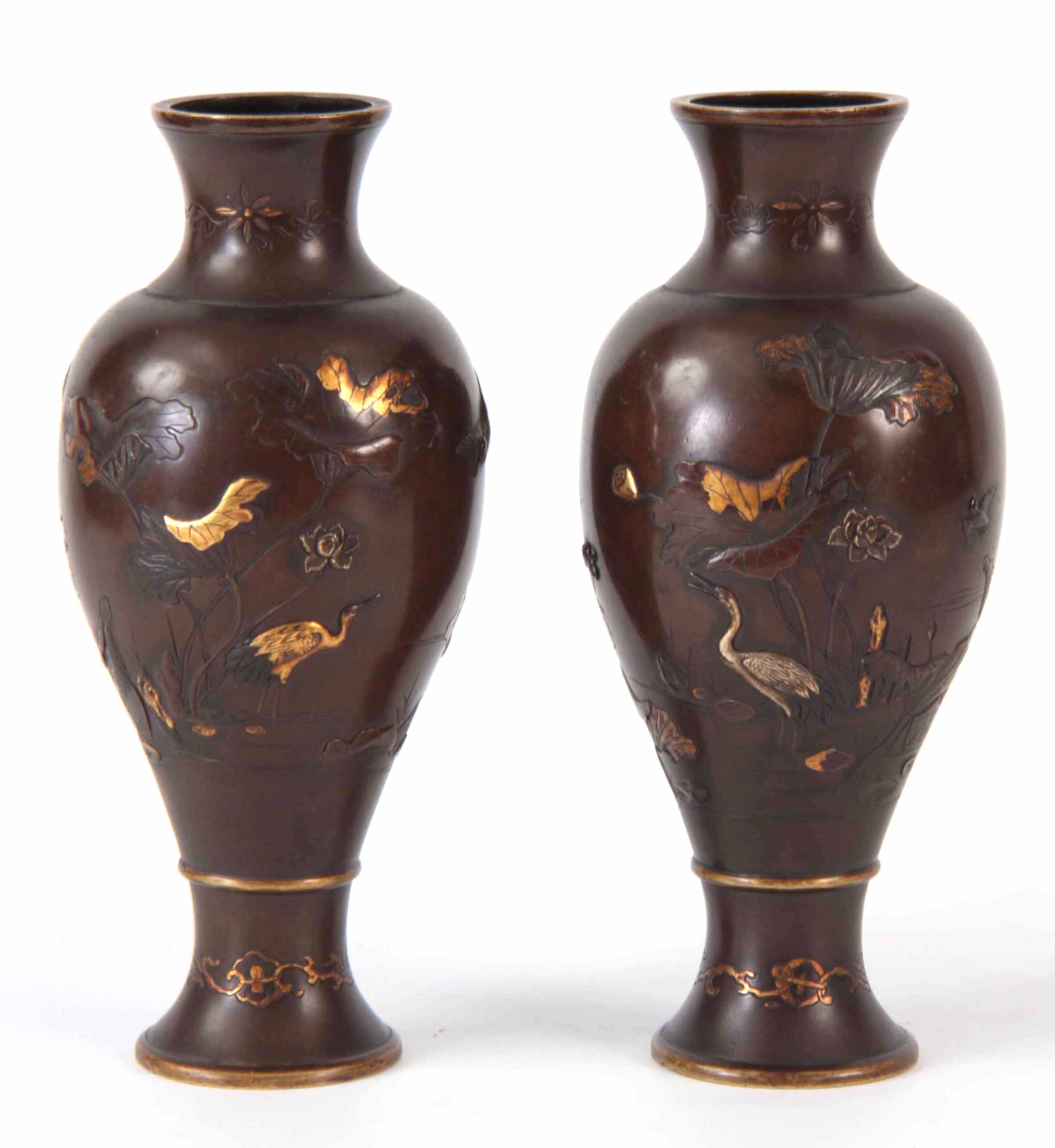 A PAIR OF MEIJI PERIOD JAPANESE BRONZE INLAID VASES decorated with gold and silver inlays of