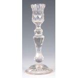 AN 18TH/EARLY 19TH CENTURY CIRCULAR BASE FACET CUT GLASS CANDLESTICK with knopped tapering stem