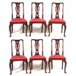 A FINE SET OF SIX GEORGE II RED WALNUT DINING ROOM CHAIRS with shaped backs and pierced vase