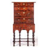 A SMALL EARLY 18TH CENTURY WALNUT CHEST ON STAND with an overhanging top above four graduated