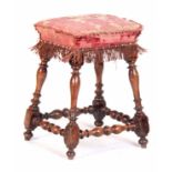 A LATE 17TH CENTURY WALNUT STOOL with ring turned supports joined by low stretchers 36cm wide 40cm