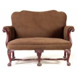 A 19TH CENTURY MAHOGANY TWO SEATER UPHOLSTERED SETTEE POSSIBLY IRISH with shaped back and eagle head