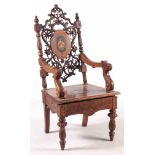 A 19TH CENTURY WALNUT BLACK FOREST MUSICAL ARMCHAIR with marquetry inlaid panels surrounded by