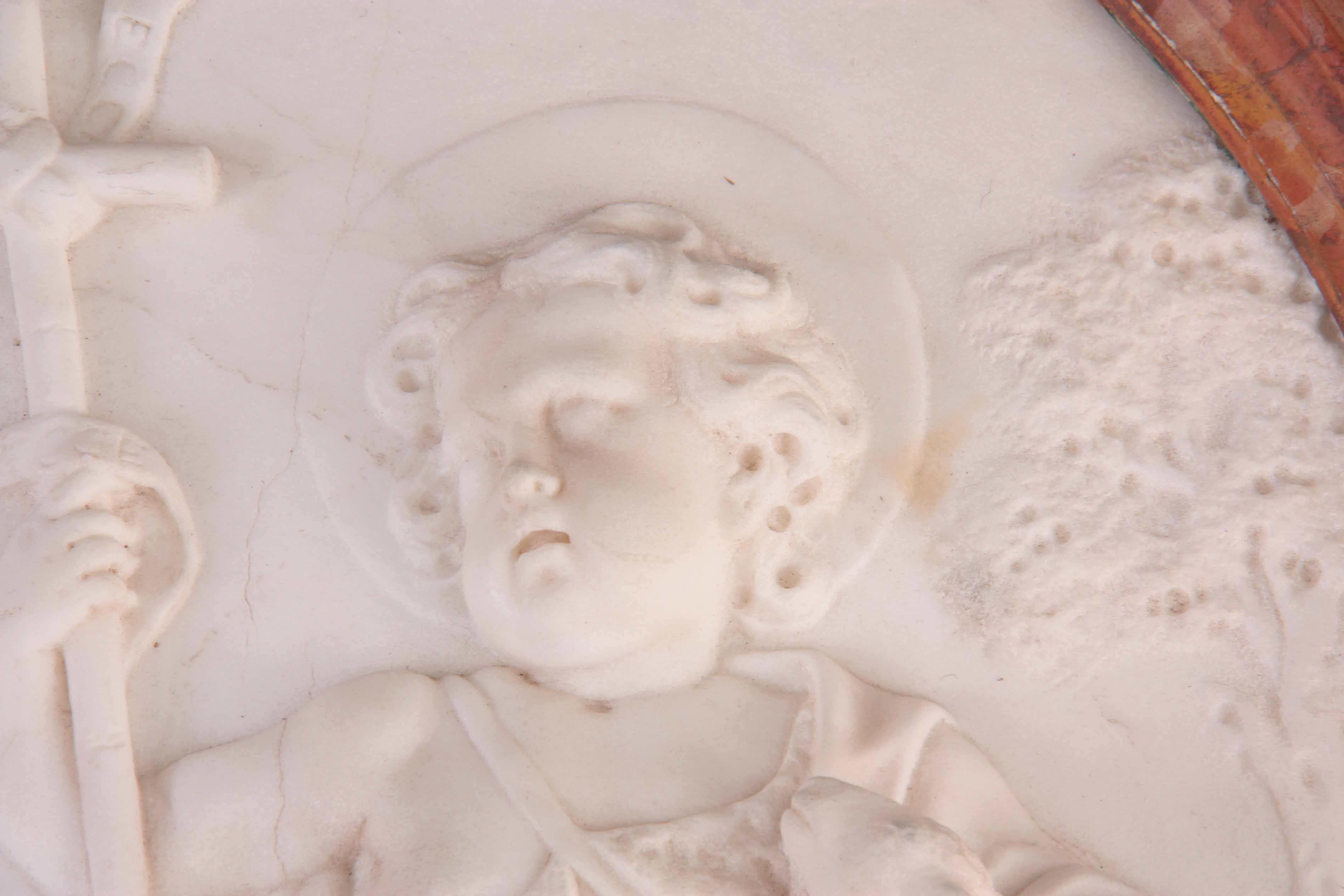 AN 18TH CENTURY OVAL CARVED WHITE MARBLE HANGING WALL PLAQUE depicting a young angel holding a - Image 2 of 7