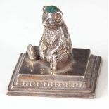 AN EARLY 20th CENTURY NOVELTY SILVER PIN CUSHION modelled as a bear sat on a square moulded base 6cm