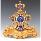 A LATE 19TH CENTURY FRENCH ORMOLU AND PORCELAIN PANELED MANTEL CLOCK having an urn finial above an