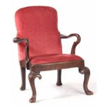 A QUEEN ANNE WALNUT UPHOLSTERED ARMCHAIR OF SMALL SIZE with shaped back, crook arms and drop in