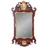 A GEORGE III MAHOGANY AND GILT GESSO HANGING MIRROR POSSIBLY IRISH with carved shells top and