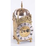 A 19TH CENTURY BRASS LANTERN CLOCK with a 7" silvered chapter ring, engraved centre and posted