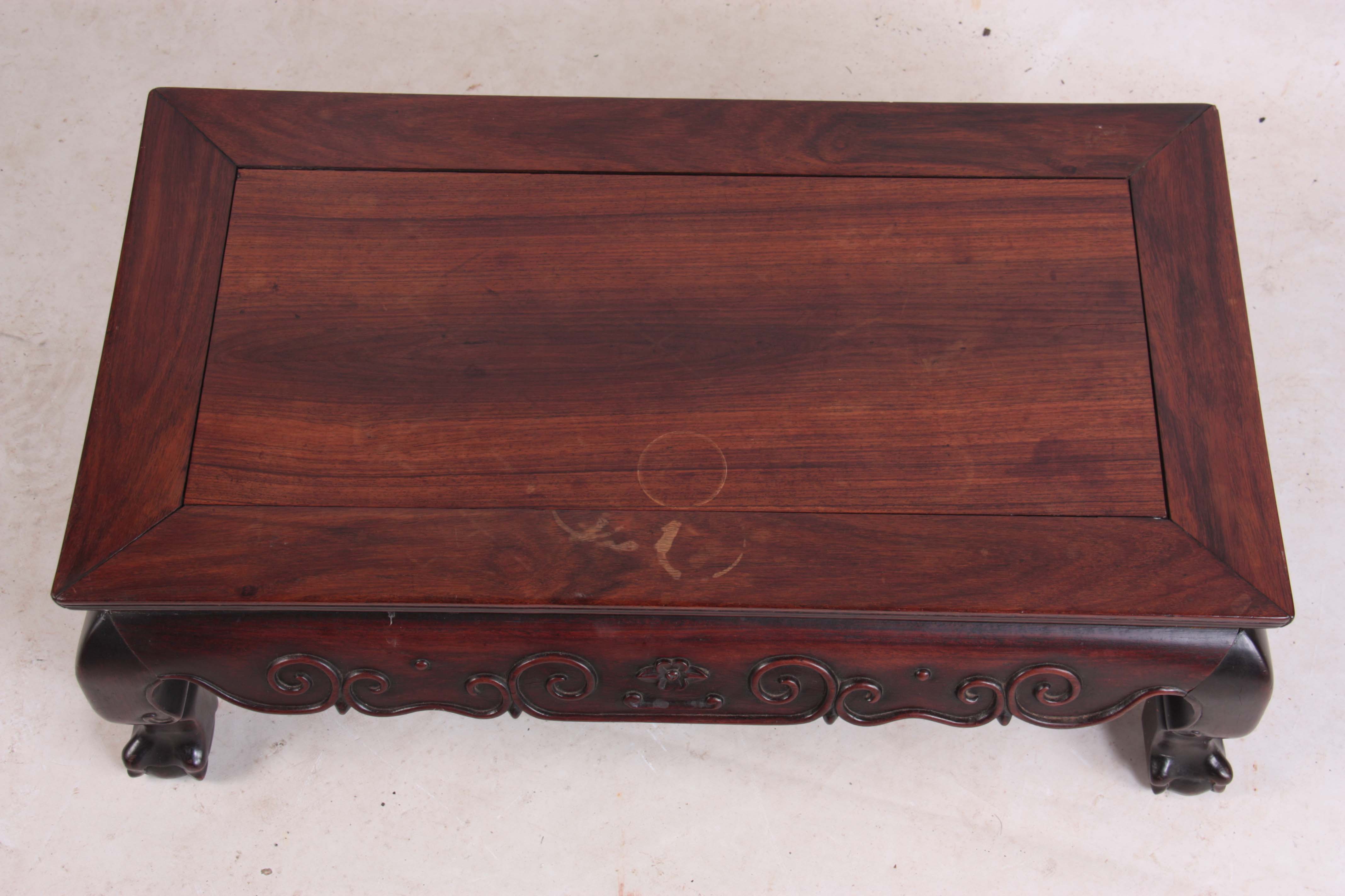 A 19TH CENTURY CHINESE HARDWOOD LOW OCCASIONAL TABLE with panelled top and shaped scroll carved base - Image 3 of 5