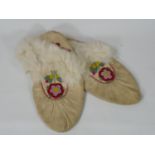 Pair of native North American moccasins with beaded floral decoration and Fur rims