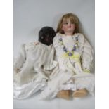 1950s Black Doll with clothing and a Edwardian Bisque headed doll with clothing. Condition: some