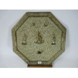 Octagonal embossed Indian Brass charger depicting Ganesha with worshippers in floral background,