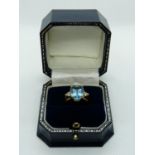 Good Quality Ladies 18ct Yellow Gold Ring with Oval Claw set Blue Topaz 4.9ct flanked by a trio of
