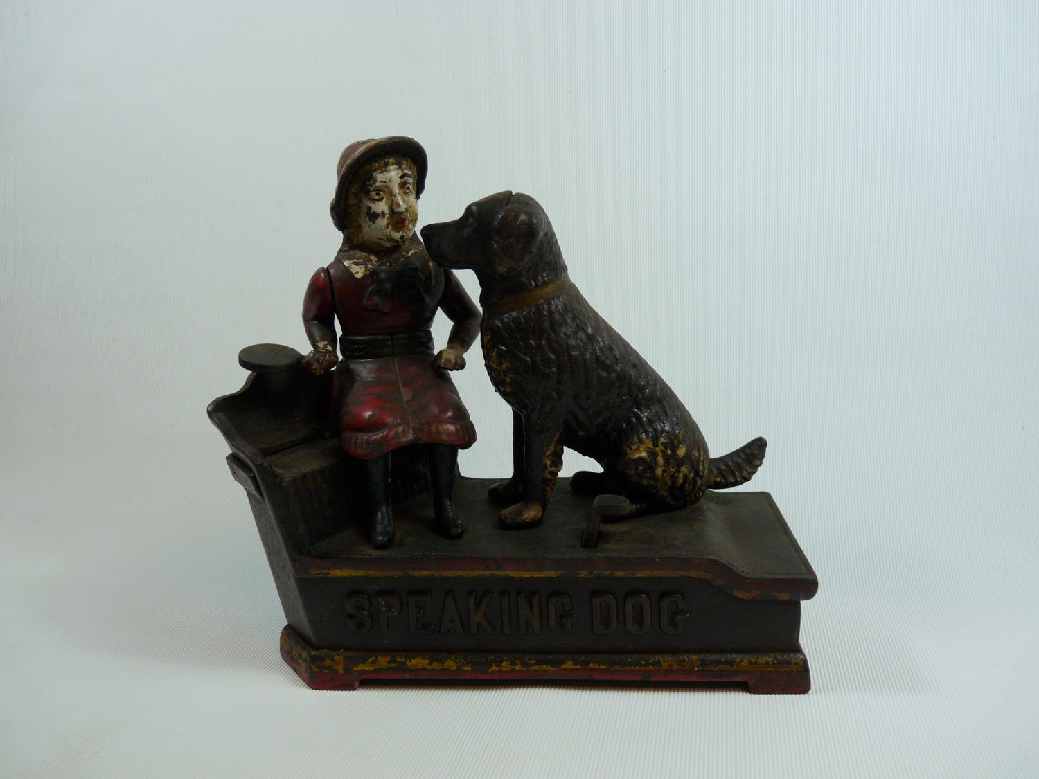 J & E Stevens Speaking Dog Cast Iron Money Bank with seated girl and dog figures on red base with