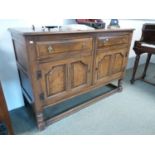 Good Quality Oak sideboard of 2 drawers with brass drop handles over panelled doors over straight