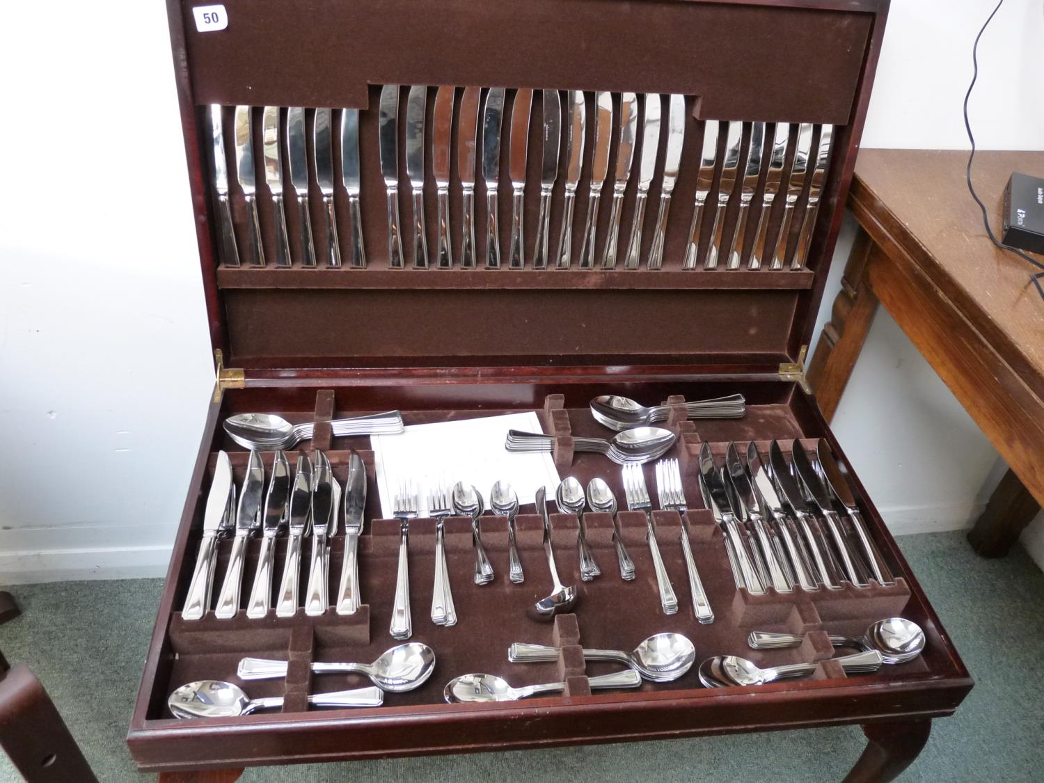 Cased Extensive Stainless Steel Cutlery Set in Leather topped Mahogany case supported on Cabriole