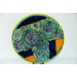 A Poole Pottery Studio charger by Tony Morris depicting Lotus Heads on multi coloured background,