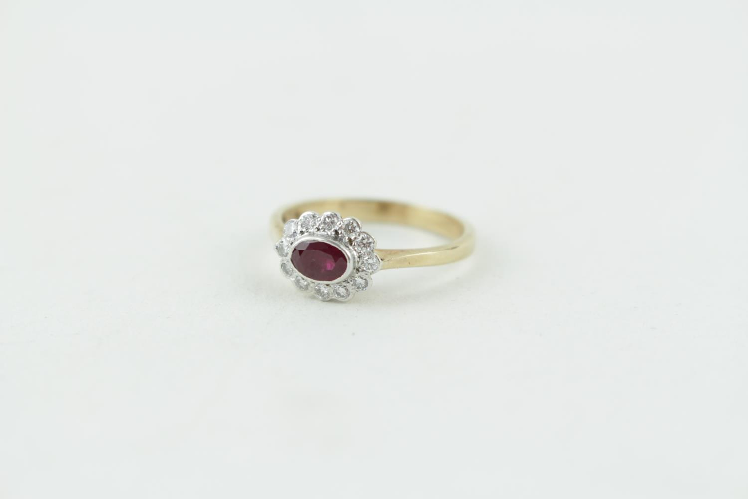 Lovely 9ct Gold Oval Ruby and Diamond cluster ring, 3g total weight. Size Q