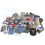 Large collection of assorted Military metal and cloth badges, dog tags, buttons and related items