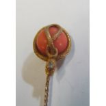 A Victorian yellow metal stick pin with snake with diamond to head wrapped around coral (i.c.)