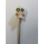 A Victorian stick pin with ivory skull terminal with white stone eyes