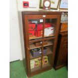 A narrow oak display cabinet