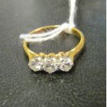 An 18ct gold three stone diamond ring