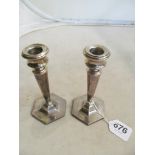 A pair of silver tapered candlesticks on octagonal bases