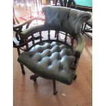 A reproduction button upholstered leather swivel desk chair