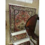 A cream and pink floral Persian style rug