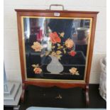 A mahogany firescreen with embroidered floral inset